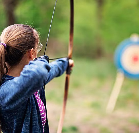 Teen using archery feild. 