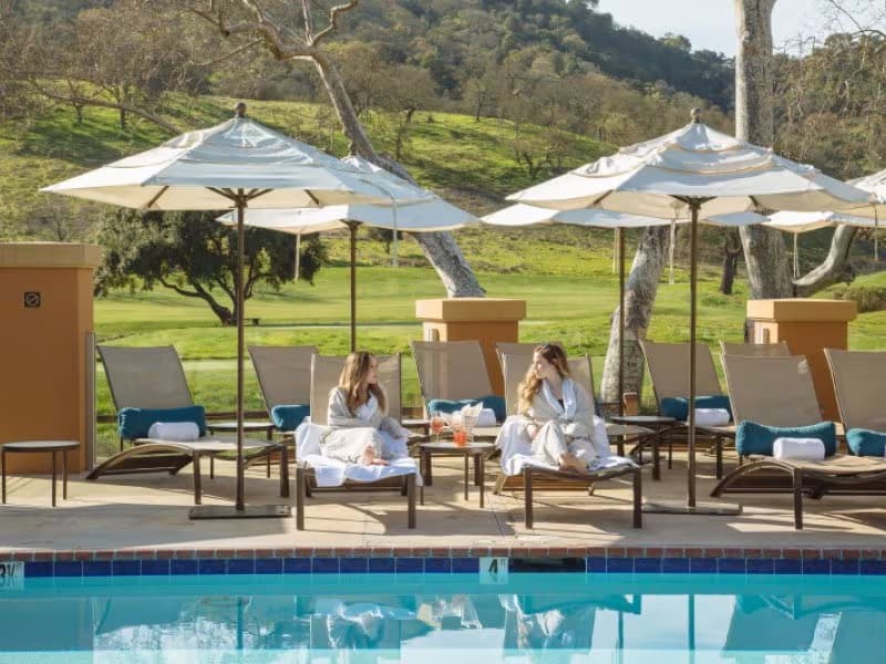 women chatting poolside